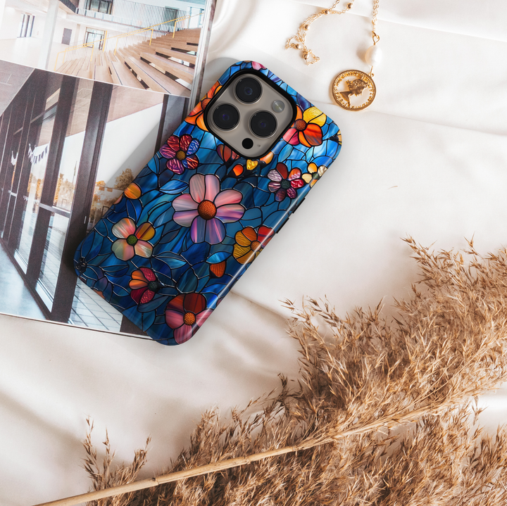 Colorful stained glass floral iPhone tough case with vibrant flowers and deep blue background