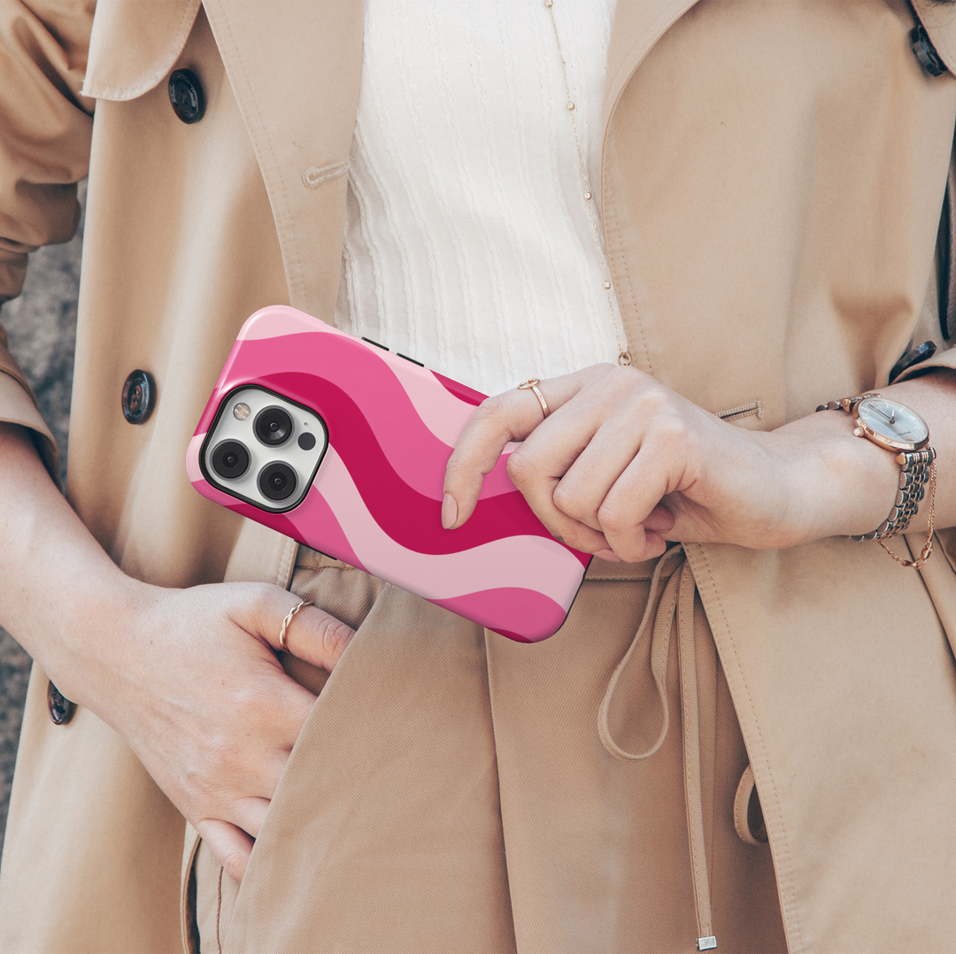 Pink Current hot pink iPhone 18 Pro Max MagSafe case featuring flowing wavy stripes in hot pink, bubblegum pink and soft blush, a cute feminine protective tough iPhone 18 Pro phone case with a retro aesthetic swirl pattern and MagSafe compatibility.
