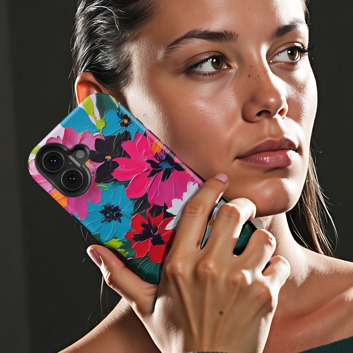 Colorful floral iPhone case featuring bold pink, blue, red, and white flowers with expressive painterly brushstrokes.