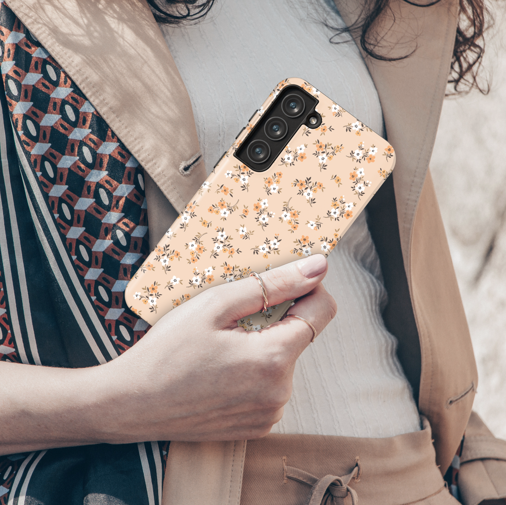 Beige Galaxy phone case with dainty orange and white flowers – warm autumn floral pattern