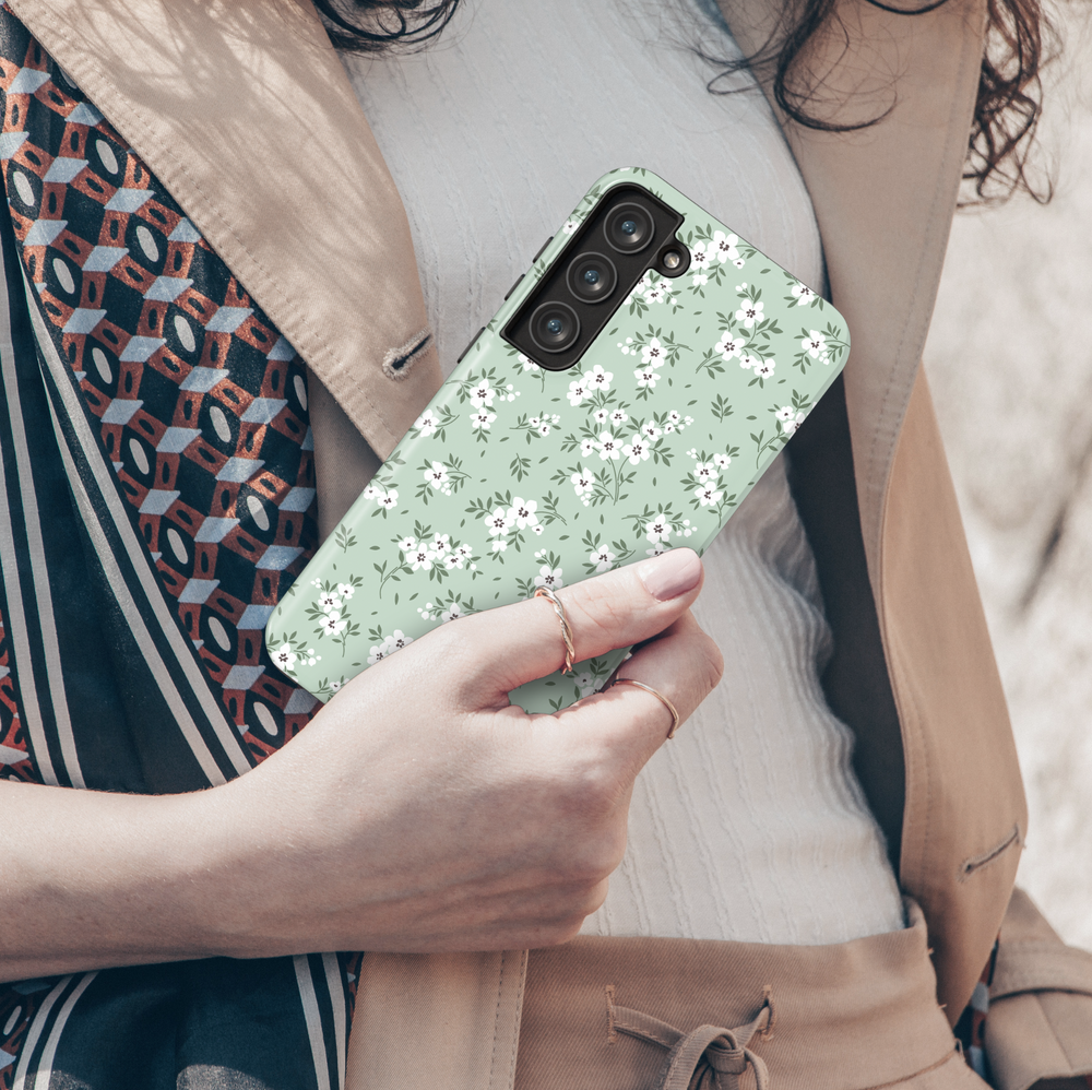 Galaxy phone case with sage green background and white floral pattern – minimalist and botanical design