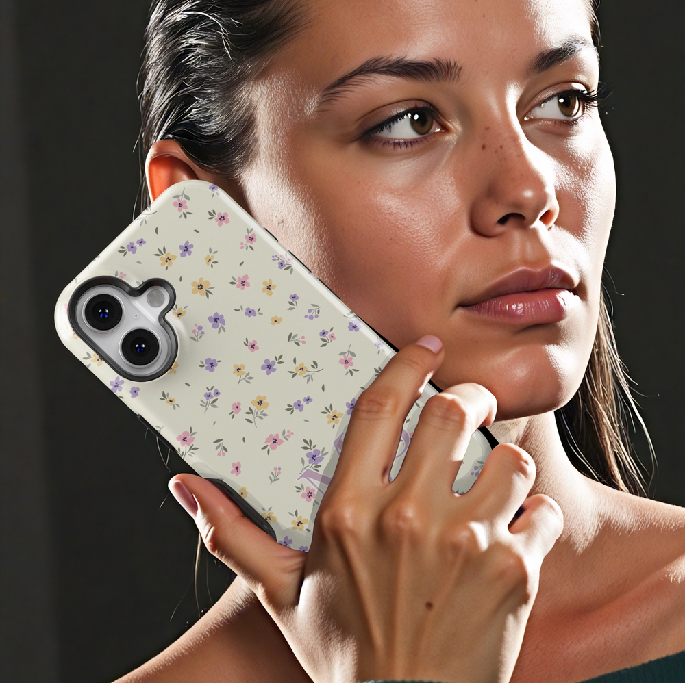 Personalized floral iPhone case with delicate pastel wildflowers and custom initials, creating a vintage, cottagecore-inspired aesthetic.