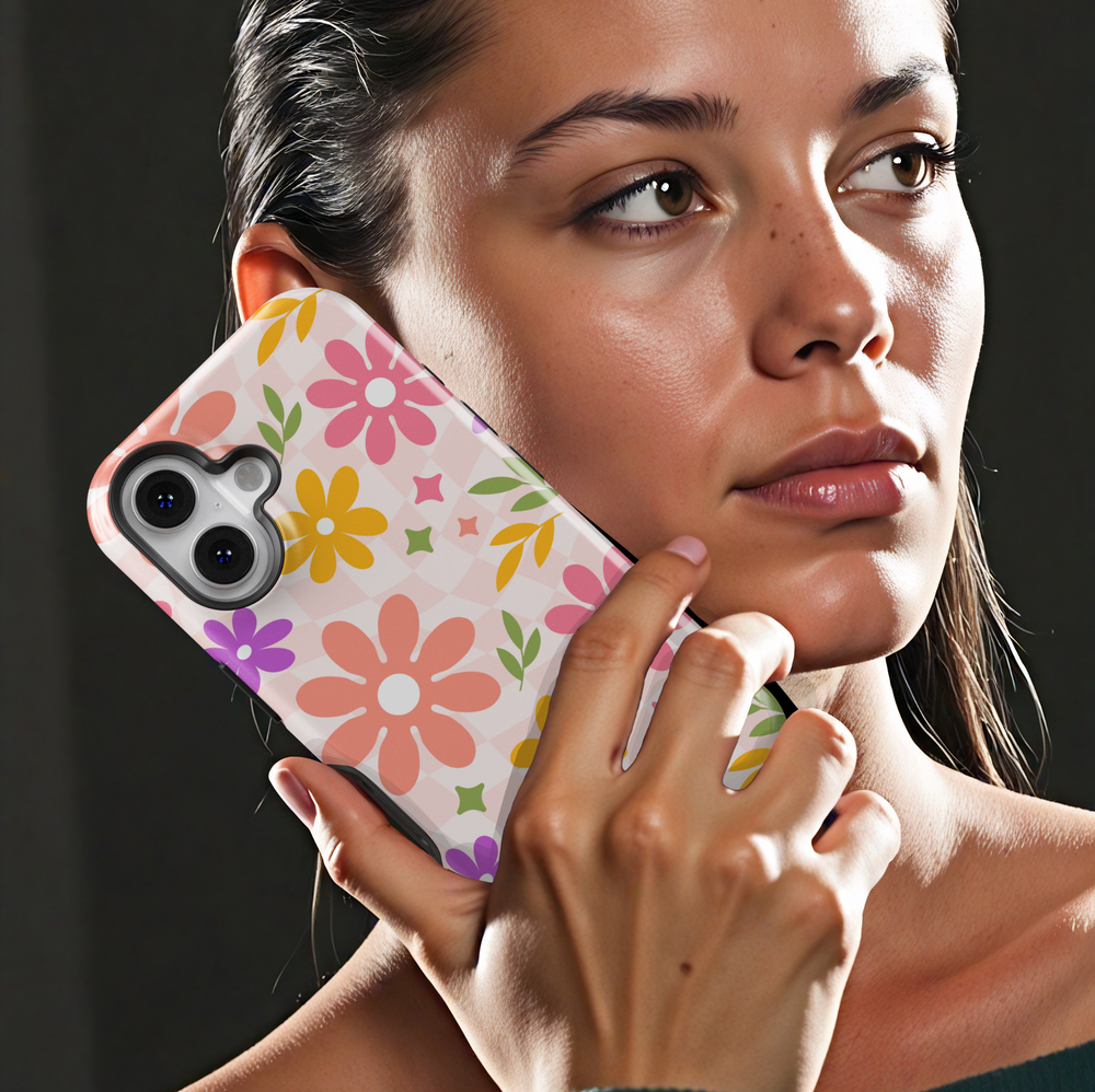 Colorful retro floral iPhone case with wavy checkered background, featuring pink, yellow, and purple flowers for a groovy aesthetic.