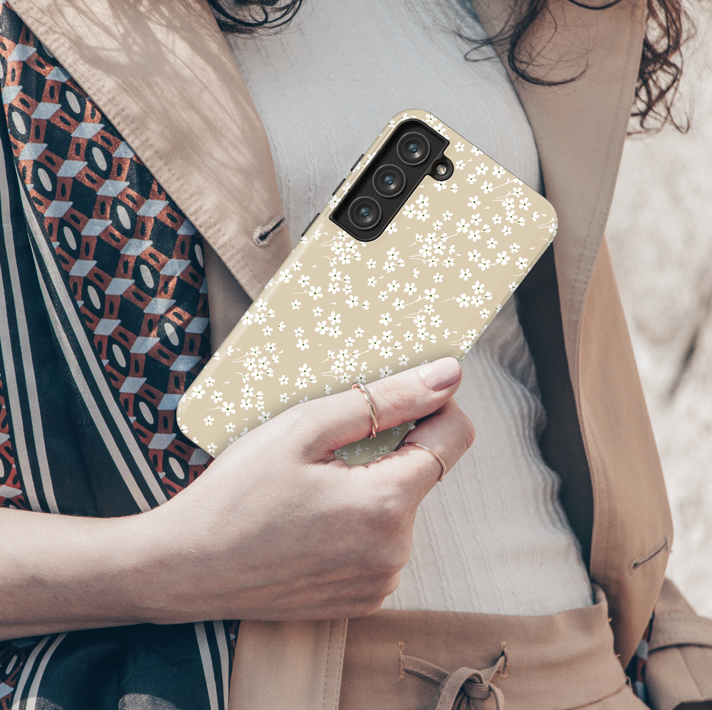 Neutral beige Galaxy case with tiny white floral pattern – minimalist aesthetic phone cover