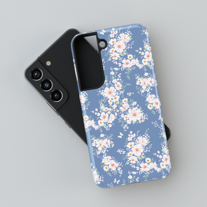 Dusty blue Samsung Galaxy phone case with light pink floral clusters – elegant feminine cover for spring vibes