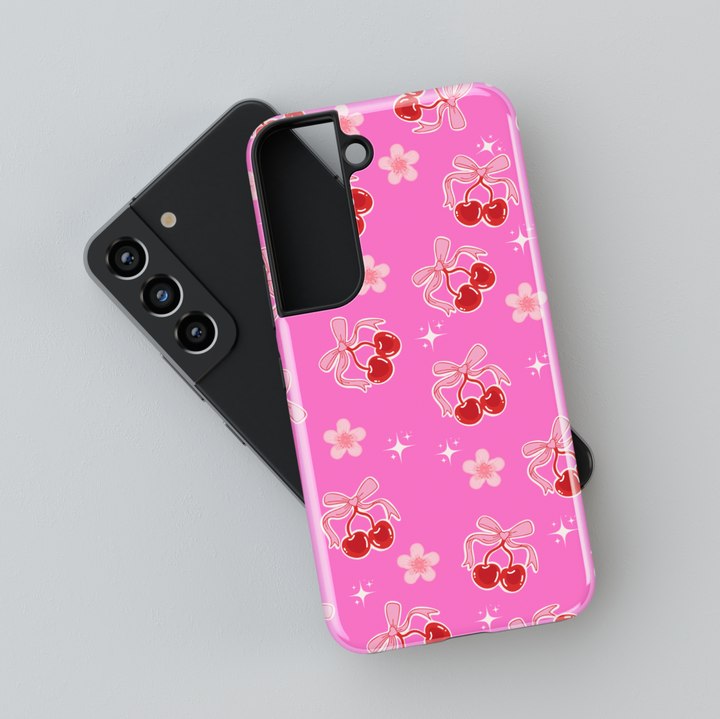 Coquette pink Samsung Galaxy case with red cherries, heart bows, and floral accents – cute girly aesthetic protective phone cover