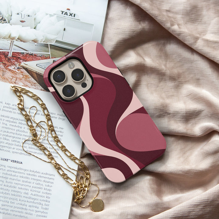 Slow Burn burgundy abstract iPhone 18 Pro Max MagSafe case featuring flowing merlot, wine red, dusty rose and blush pink waves, a feminine retro aesthetic protective tough iPhone 18 Pro phone case with a modern swirl design and MagSafe compatibility.
