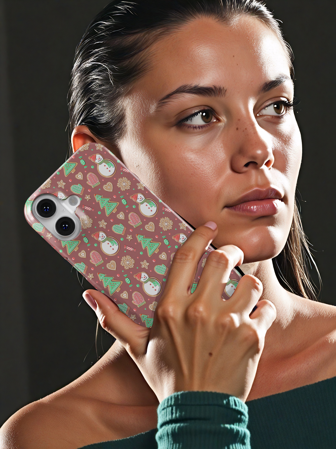 Cute Christmas iPhone case with gingerbread snowmen, holiday cookies, mittens, and festive icons on a warm pink background